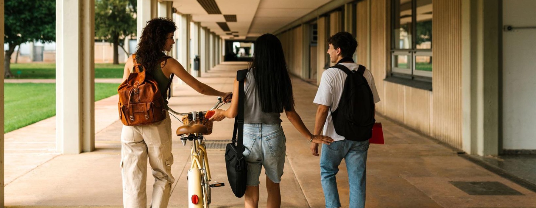 a group of people walking down a sidewalk